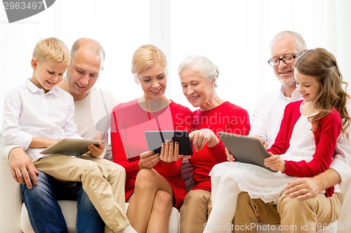 Image of smiling family with tablet pc computers at home