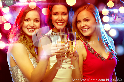 Image of three smiling women with champagne glasses