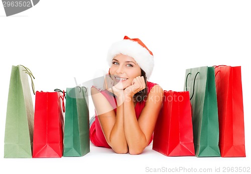 Image of woman in red shirt with shopping bags