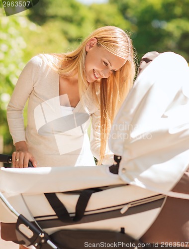 Image of happy mother with stroller in park