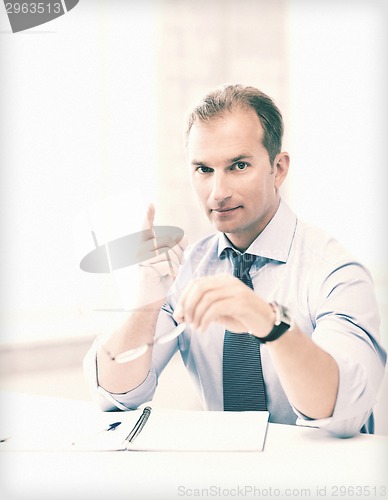 Image of businessman showing warning gesture