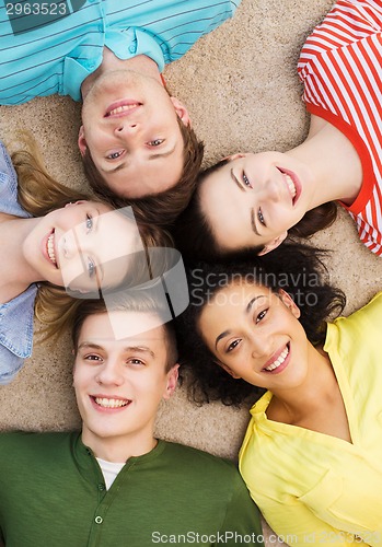 Image of group of smiling people lying down on floor