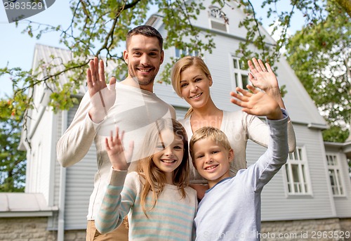 Image of happy family in front of house outdoors