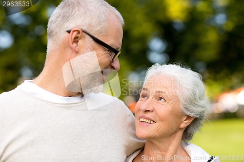 Image of senior couple hugging in city park