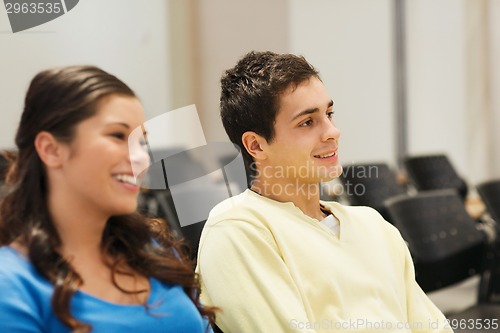 Image of group of smiling students in lecture hall