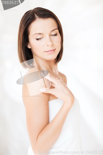 Image of beautiful woman standing in towel