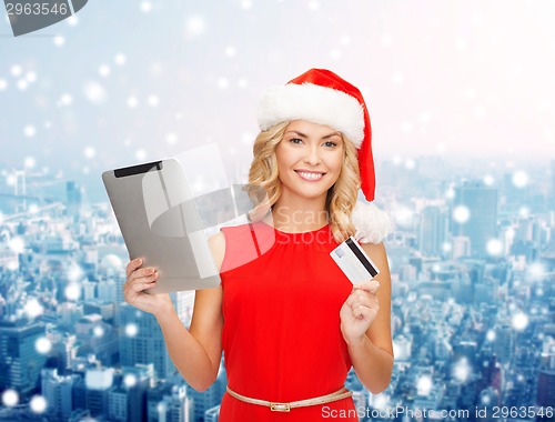 Image of woman in santa hat with tablet pc and credit card