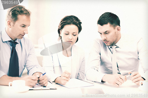 Image of business team discussing something in office