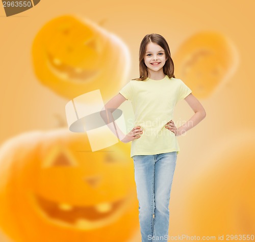 Image of smiling girl over pumpkins background