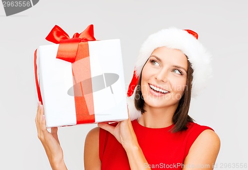 Image of smiling woman in santa helper hat with gift box