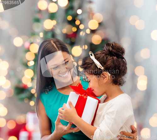 Image of happy mother and little girl with gift box