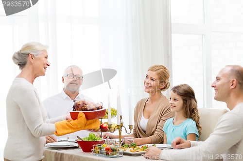 Image of smiling family having holiday dinner at home