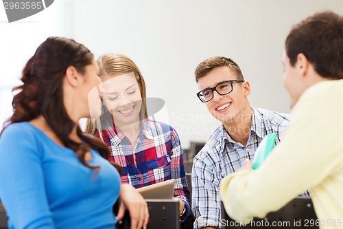 Image of group of smiling students in lecture hall