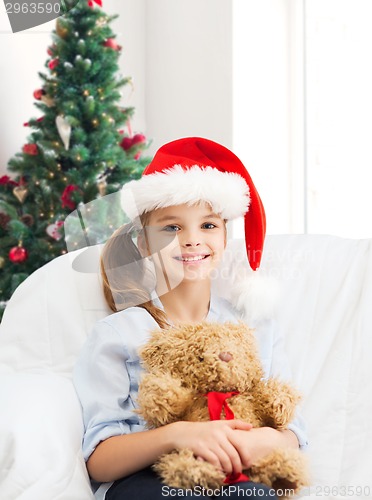 Image of smiling little girl with teddy bear