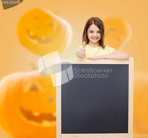 Image of smiling little girl with blackboard