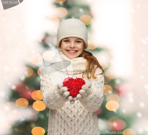 Image of girl in winter clothes with small red heart