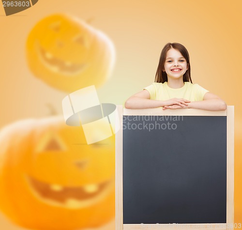 Image of smiling little girl with blackboard