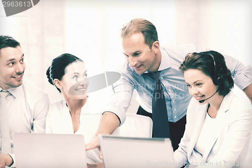 Image of group of people working in call center