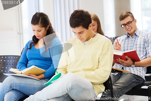 Image of group of smiling students with notebooks