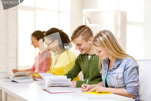 Image of students with textbooks and books at school