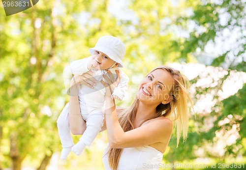 Image of happy mother with little baby in park