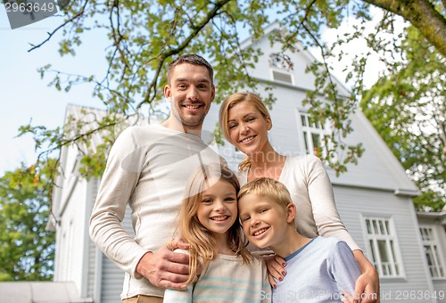 Image of happy family in front of house outdoors