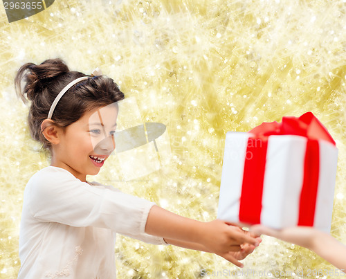 Image of smiling little girl with gift box