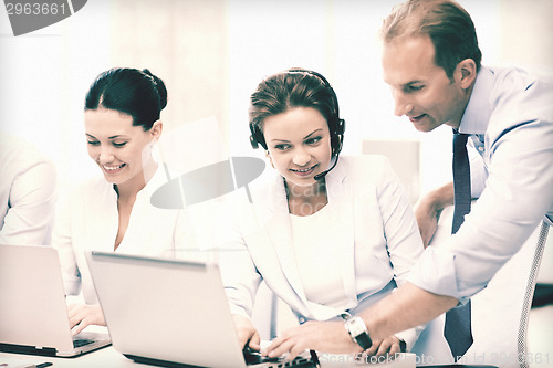 Image of group of people working in call center