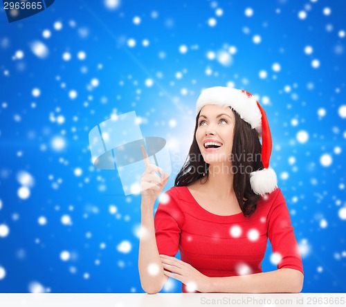 Image of smiling woman in santa helper hat