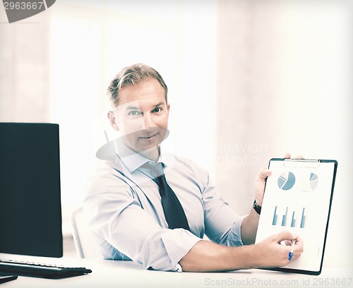 Image of businessman showing graphs and charts