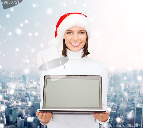 Image of woman in santa helper hat with laptop computer