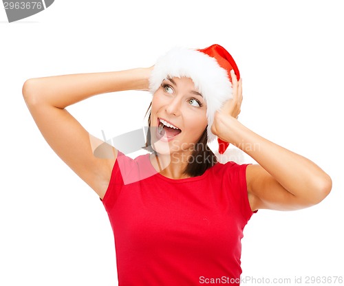 Image of surprised woman in santa helper hat