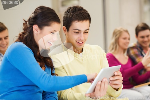 Image of group of smiling students with tablet pc