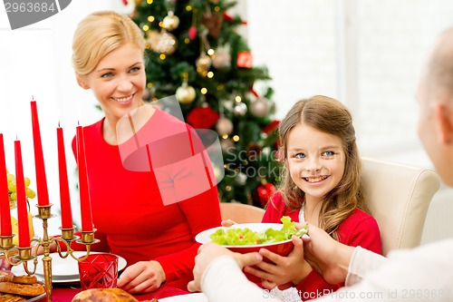 Image of smiling family having holiday dinner at home