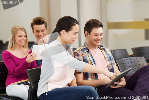 Image of group of smiling students with tablet pc