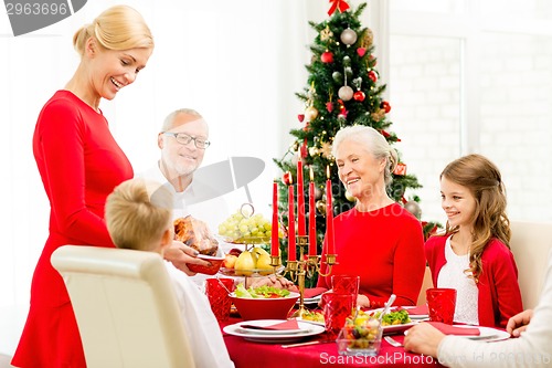 Image of smiling family having holiday dinner at home