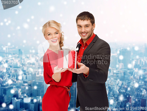 Image of smiling man and woman with present