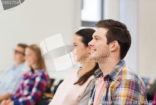 Image of group of smiling students in lecture hall