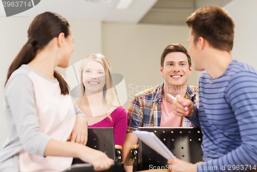 Image of group of smiling students with notebook