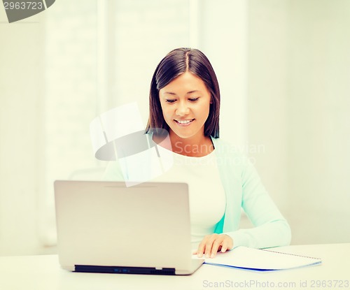 Image of asian businesswoman with laptop and documents