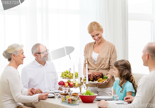 Image of smiling family having holiday dinner at home