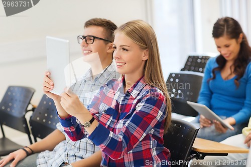 Image of group of smiling students with tablet pc