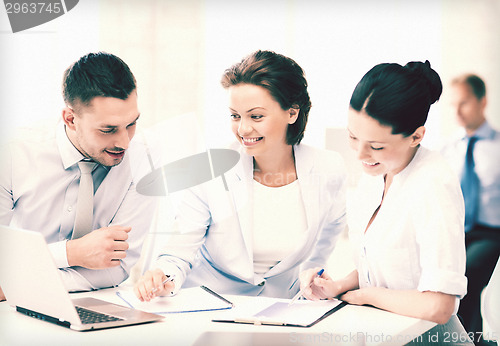 Image of business team discussing something in office