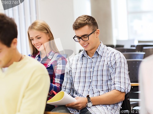 Image of group of smiling students with notebook