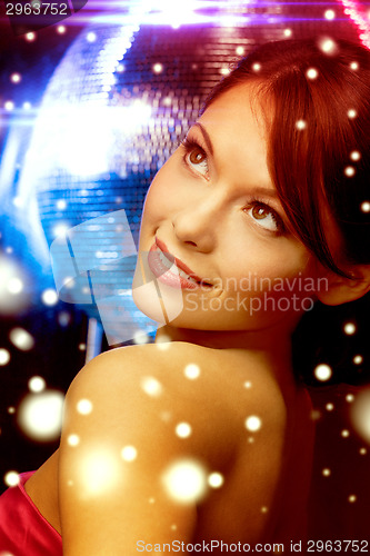 Image of woman in evening dress wearing diamond earrings