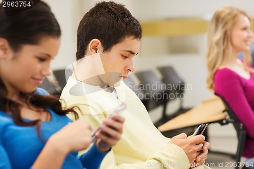 Image of group of smiling students in lecture hall