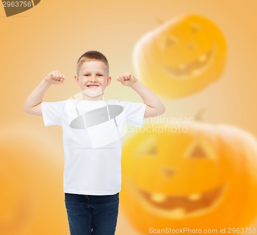 Image of smiling boy over pumpkins background