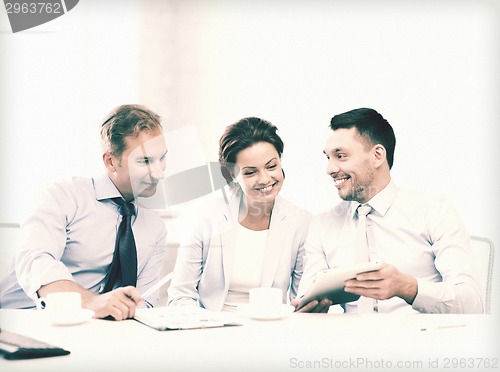 Image of business team having fun with tablet pc in office