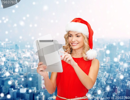Image of woman in santa helper hat with tablet pc