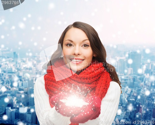 Image of smiling woman in winter clothes with snowflake